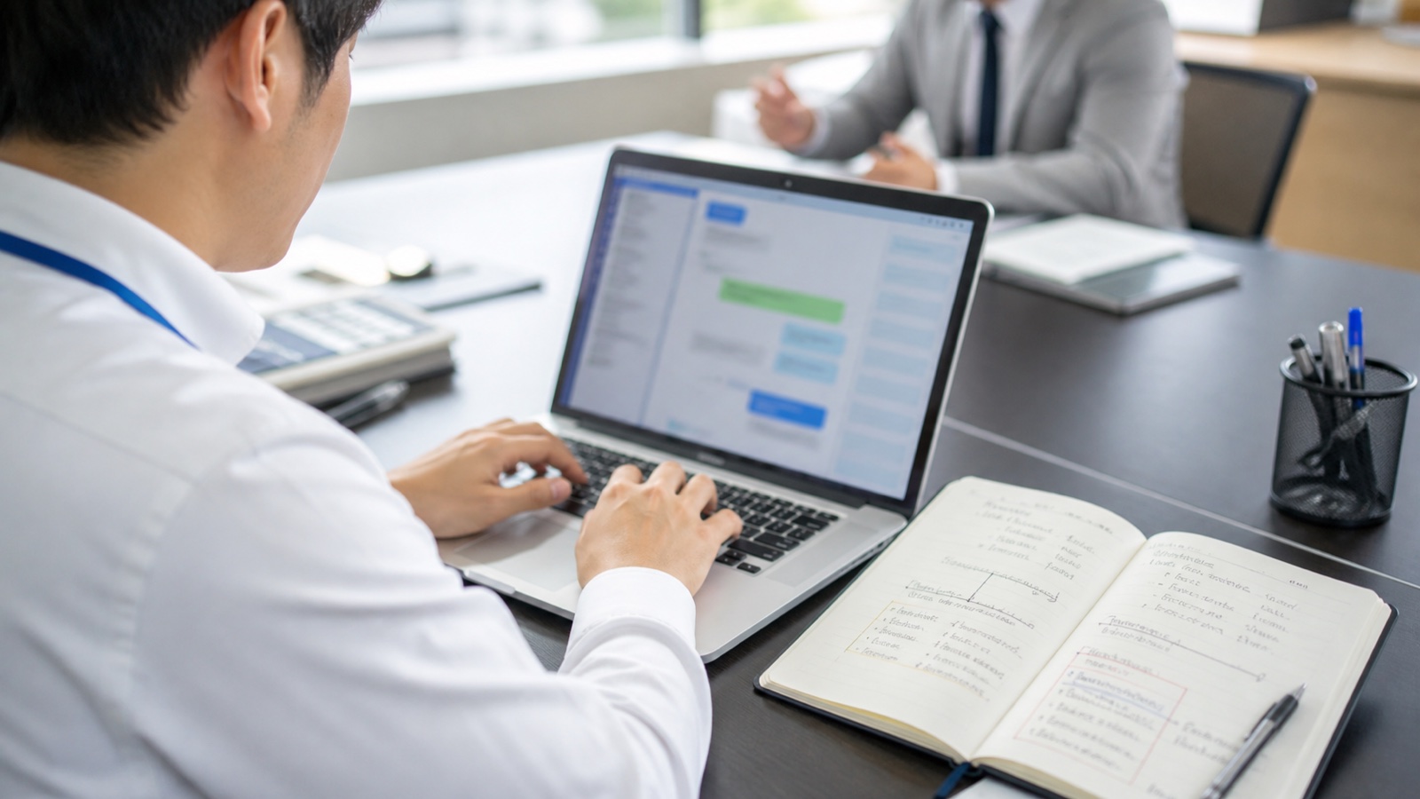 口頭の指示をメールとチャットで記録する会社員